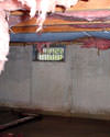 Washington crawl space with vents, showing mold, rot, and fiberglass insulation dripping off the ceiling.