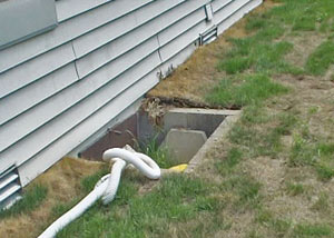 The ugly, old concrete window well of a Silverdale crawl space