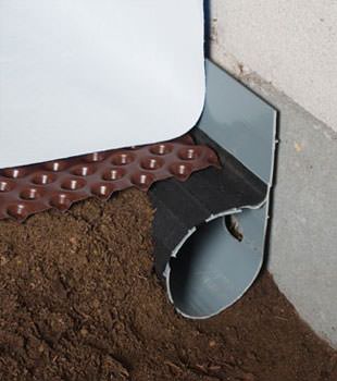 Closeup of a crawl space drainage system installed in Allyn