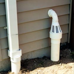 A grated sump pump discharge line fitting in Seabeck