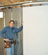 Installing wall panels on top of our basement wall insulation in Aberdeen