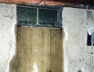 Water pouring out from a basement window in Port Angeles